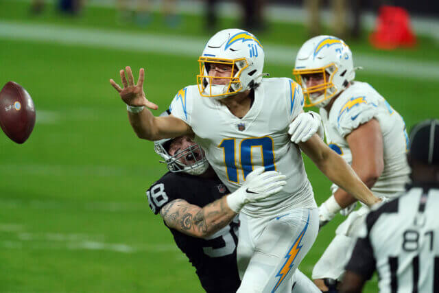 Dec 17, 2020; Paradise, Nevada, USA; Los Angeles Chargers quarterback Justin Herbert (10) throws as Las Vegas Raiders defensive end Maxx Crosby (98) moves in for a tackle during the first half at Allegiant Stadium. Mandatory Credit: Kirby Lee-USA TODAY Sports Maxx Crosby, Justin Herbert, Chargers, Raiders